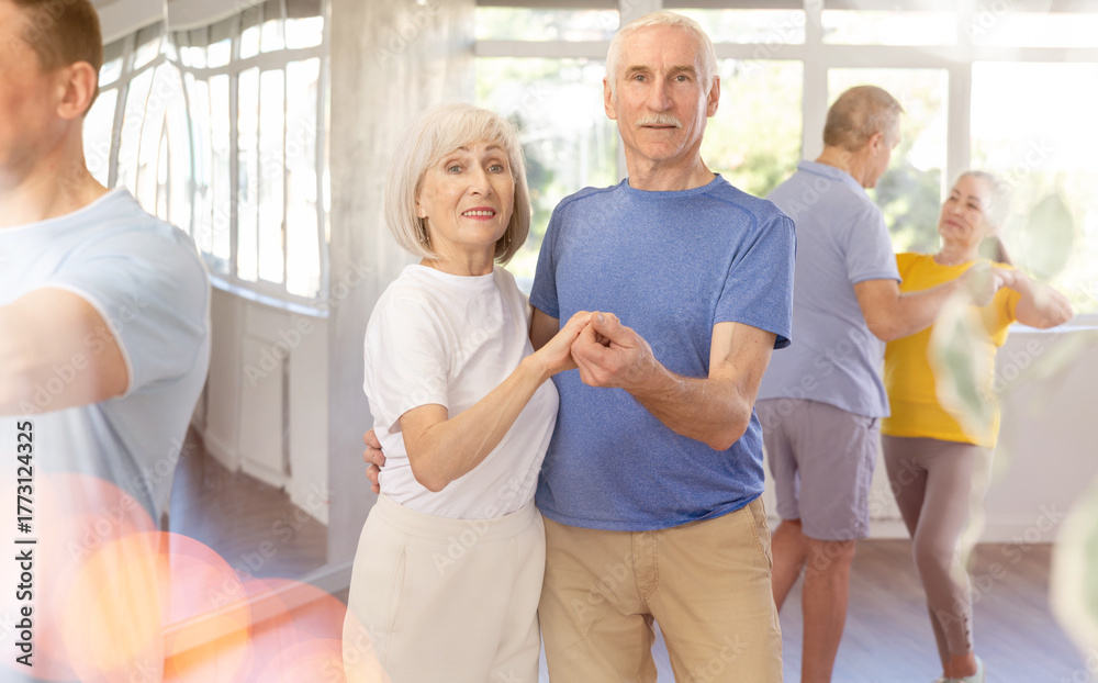 Obraz premium Elderly man and elderly woman dance ballroom dance waltz in studio