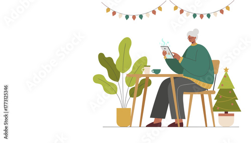 Happy senior woman using tablet at home celebrating Christmas and connecting online