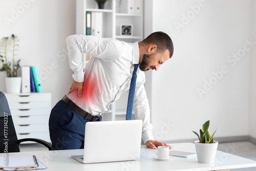 Young businessman suffering...