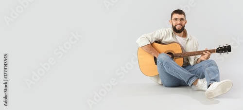 Young bearded man playing g...