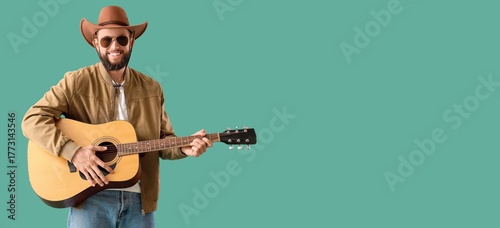 Handsome cowboy playing gui...