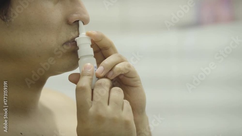 rhinitis, medicine and healthcare concept, close up of sick man using nasal spray