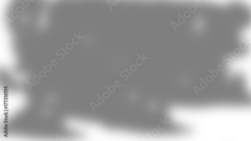 An abstract, blurred, and distorted grayscale shape resembling a map or landmass on a white background.