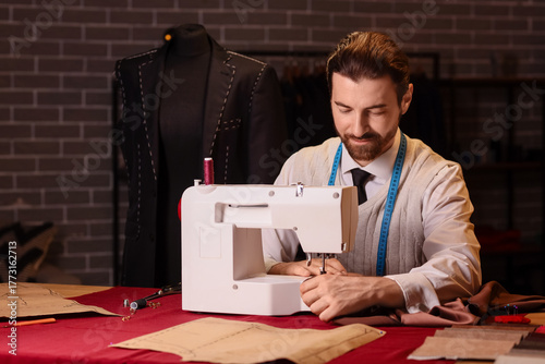 Male tailor sewing clothes ...