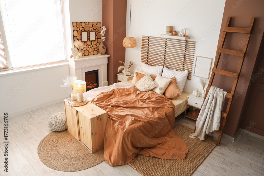Naklejka premium Interior of modern bedroom with comfortable bed, stepladder and fireplace