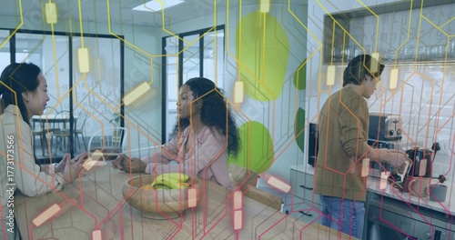 Chatting coworkers in business attire preparing coffee at espresso machine in office kitchen