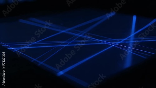 Abstract Blue Laser Beams Intersecting on a Dark Surface.