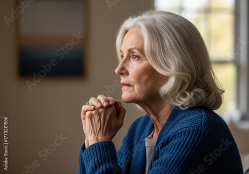 Close up profile of an elegant senior woman with silver hair deep in thought