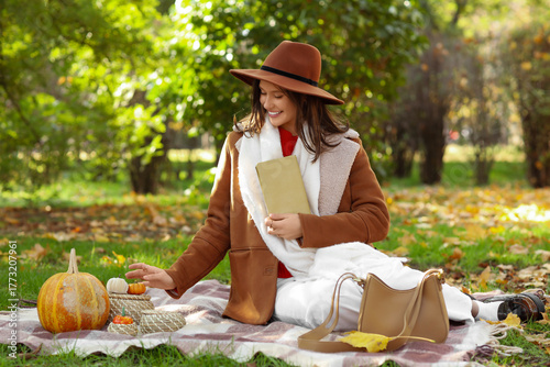Happy young woman with book...