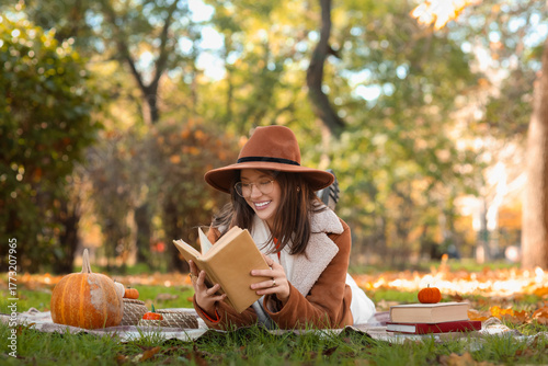Happy young woman with book...