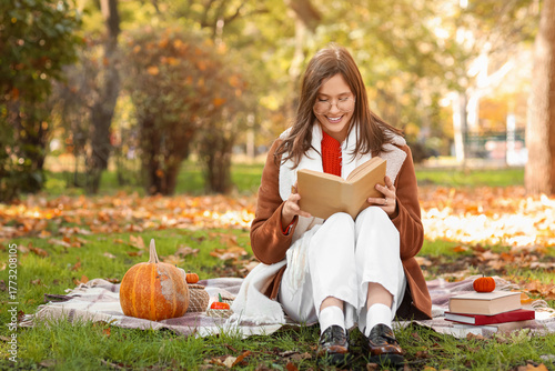 Happy young woman with book...