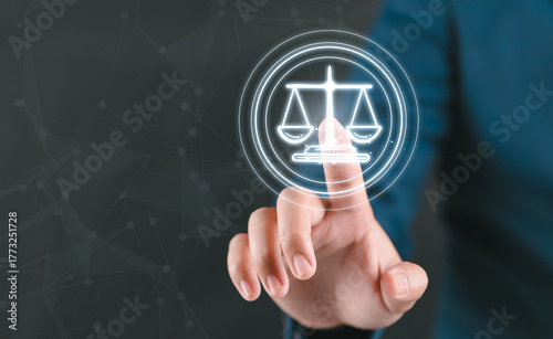 Law and justice merges with technology as finger touches glowing cyber law scale symbol representing lawyer services and ai in law innovation.