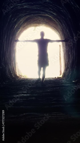 Vertical video. A Man Walks Toward the Blinding Light with Arms Outstretched Symbolizing Liberation, Acceptance, and Step into a New Beginning Concept