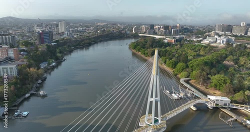 Pull out with slight left panning motion of Kangaroo Point Bridge on the Brisbane River with Brisbane CBD in background, it is a pedestrian bridge only,opened late 2024, Brisbane,Queensland, Australia