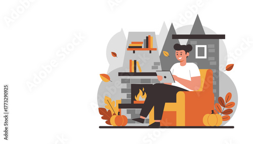 Man enjoying cozy autumn evening relaxing by the fireplace while using a tablet
