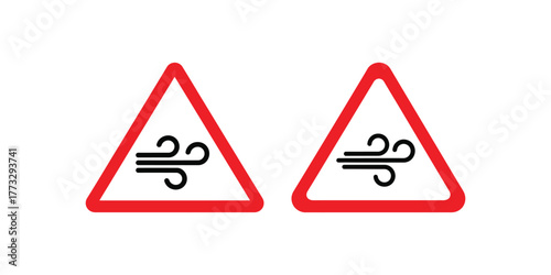 Two identical triangular road signs warning of strong crosswinds or gusts of wind on the road