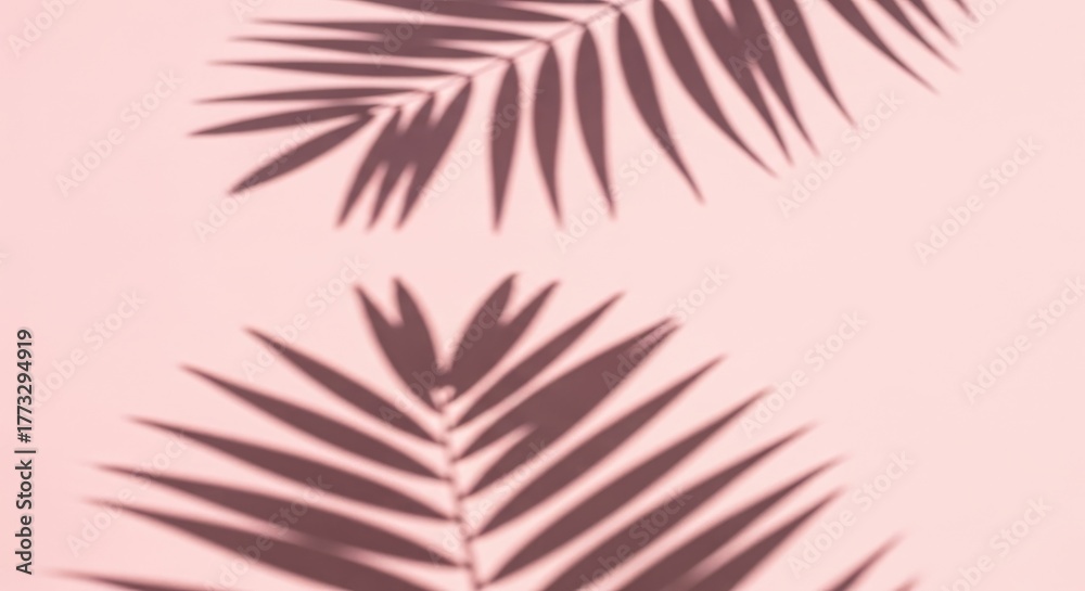 Naklejka premium Palm leaf shadows on a pink background creating a tropical and minimalist aesthetic.
