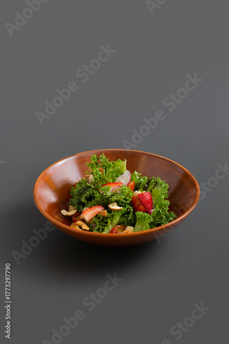 Mixed salad with Balsamic Olive Oil Dressing on grey background. Healthy green vegetable salad.