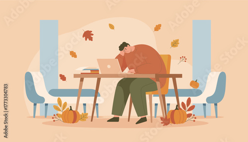 Tired man working remotely at his autumn home office desk suffering from stress and fatigue