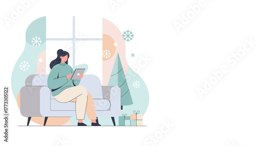 Woman uses tablet on couch at home surrounded by holiday decorations and snowflakes Online shopping concept