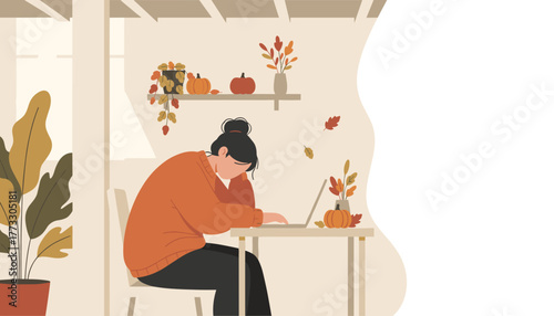 Exhausted woman working on laptop at home office decorated for autumn Copy space available