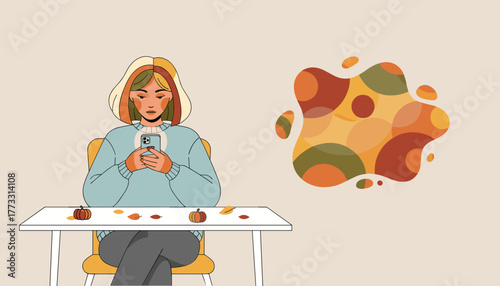 Young woman using smartphone at a table decorated for autumn featuring abstract fall colors