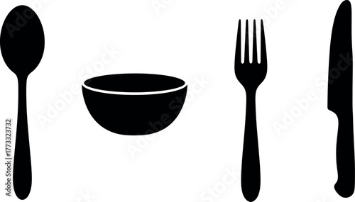 The silverware setting, including spoon, fork, and knife, rests isolated on an empty white plate for dinner