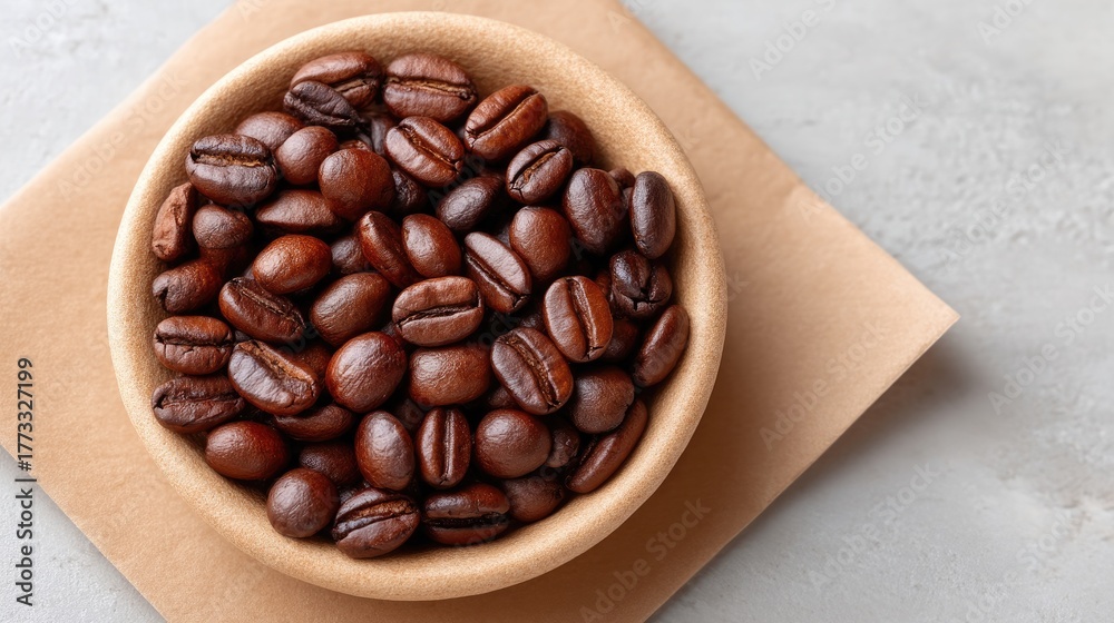 Fototapeta premium Rustic Rustic Flat Lay Of Roasted Coffee Beans In A Bowl On Brown Paper With Textured Background Overhead View