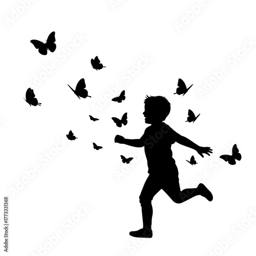 Silhouette of a happy child running with a swarm of butterflies