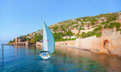 Fototapeta Naklejka Na Ścianę i Meble -  Landscape of ancient shipyard near of Kizil Kule tower with lone yacht - Alanya peninsula, Turkey