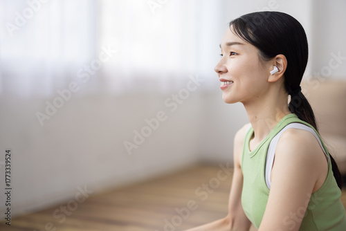 Free Download Smiling Japanese Woman Wearing Wireless Earphones in Tank Top - GFXLoad