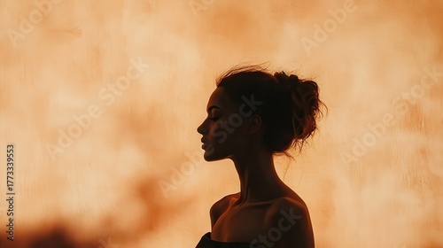 Woman's silhouette against a warm, glowing background in a serene environment during sunset
