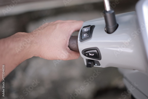 close up of a hand holding a remote control