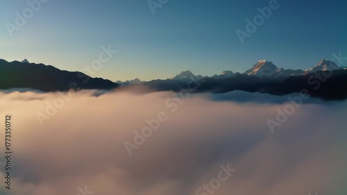 Majestic Mountain Peaks Emerge from a Sea of Clouds at Sunrise.