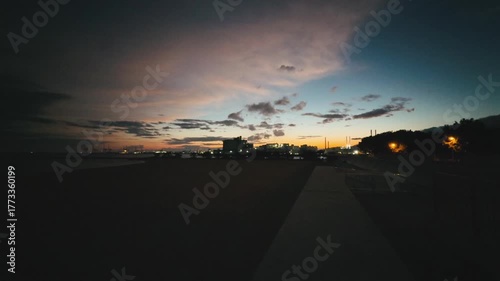 Wide angle view of a calm town under a colorful sunset sky 