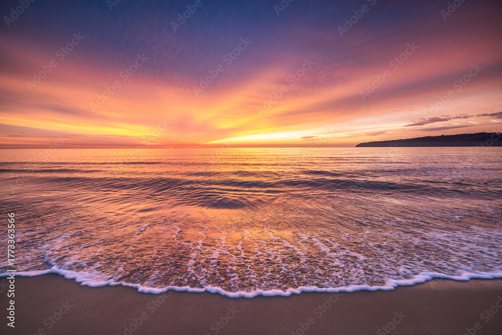Fototapeta premium Beach sunrise over the tropical sea horizon and beach