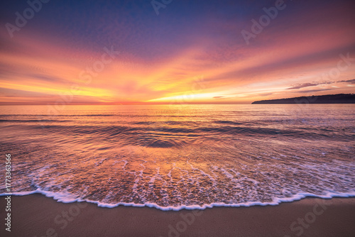 Beach sunrise over the tropical sea horizon and beach