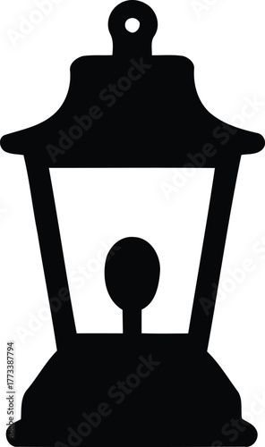 Silhouette of a traditional lantern emitting warm light in the darkness