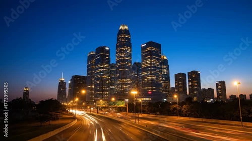 City skyline at dusk with light trails and skyscraper buildings