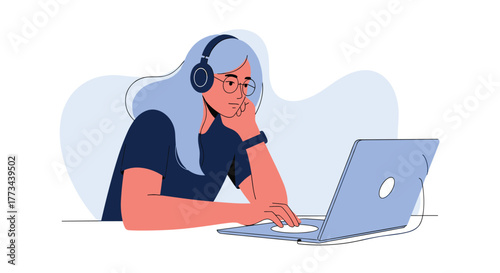 A concentrated young woman with headphones and glasses, deeply engrossed in her laptop for online learning, remote work, or creative tasks.