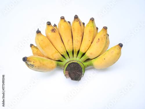 Ripe bananas in a fan like bunch, yellow with brown specks, still attached to a fresh green stem. Displayed on white for a clean, vibrant tropical look.