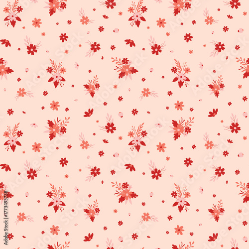 Delicate ditsy floral seamless pattern. Small red and coral flowers on a soft blush pink background.