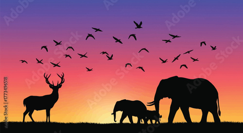 Silhouette of deer and elephants with birds flying in a colorful sky at sunset or sunrise scene