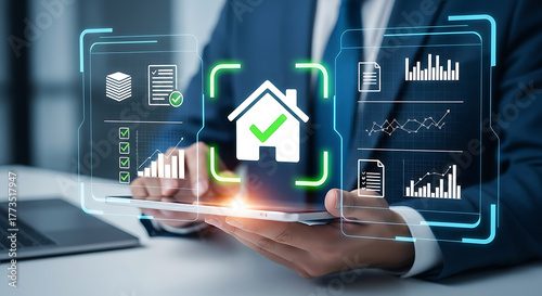 Businessman using tablet with house icon, real estate investment concept