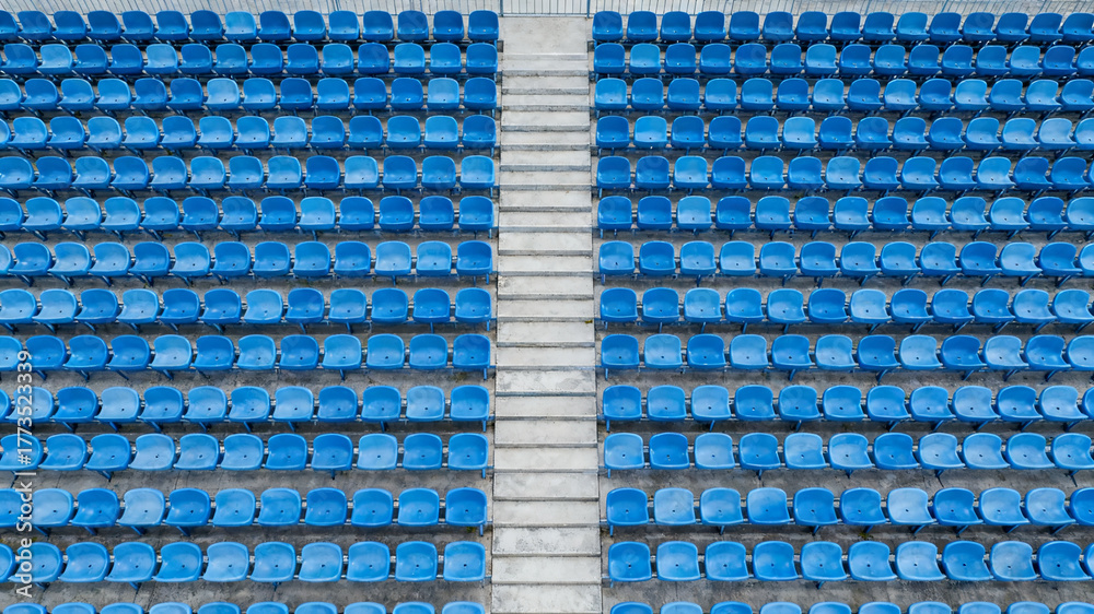 Naklejka premium Symmetrical blue stadium seats from above, a serene geometric pattern of empty spaces