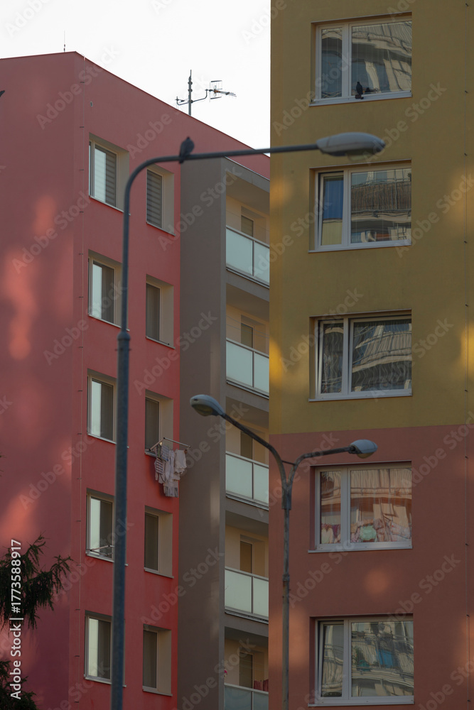 Fototapeta premium Colorful apartment buildings in a lively urban scene. Modern residential architecture showing vibrant city life and community diversity.