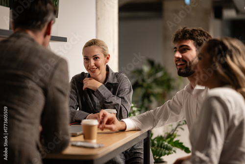 Business colleagues discussing during a coffee break in office