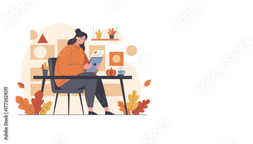 Cozy woman reading a document on a tablet at a table in an autumnal setting