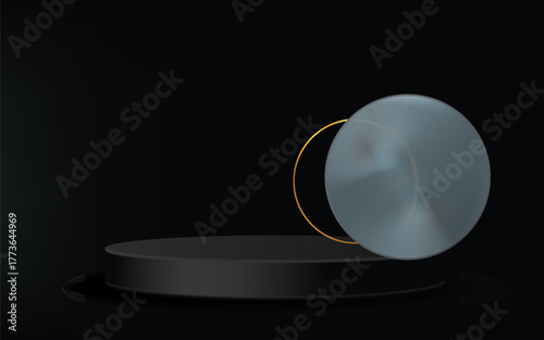 A sleek black cylindrical pedestal displays a metallic circular object with a golden rim against a dark background.