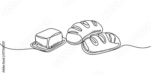 fresh bread loaves with a block of butter, symbolizing breakfast, bakery, and homemade food.